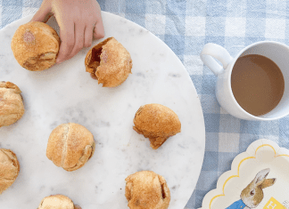Image: Child's hand taking a Resurrection Roll off of a plate to enjoy