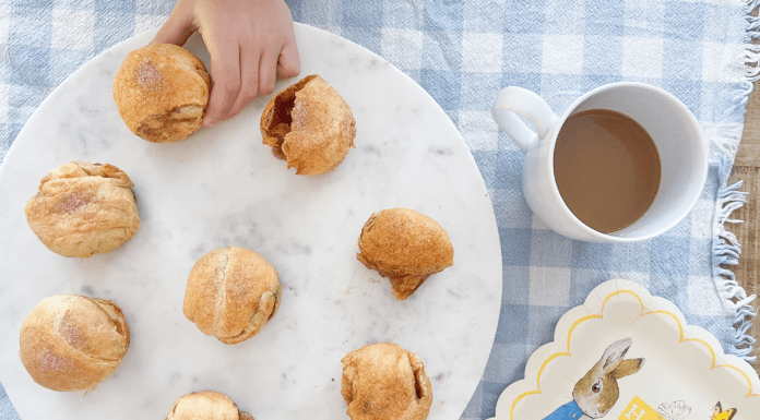 Image: Child's hand taking a Resurrection Roll off of a plate to enjoy