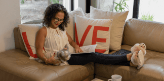 Adita, sitting on the couch with her feet up