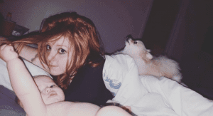 Mom sleeping with her baby and dog