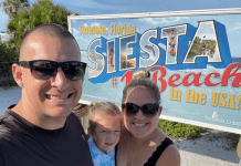 Holly's son with his family in front of a Siesta Beach sign