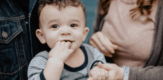 Families and transitions: A little boy, pictured with his parents, holding his mother's hand