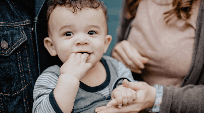 Families and transitions: A little boy, pictured with his parents, holding his mother's hand