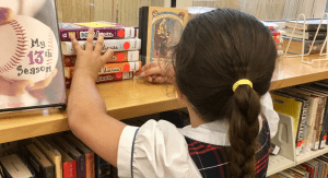 Image: A child looks for books at a local library