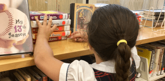 Image: A child looks for books at a local library