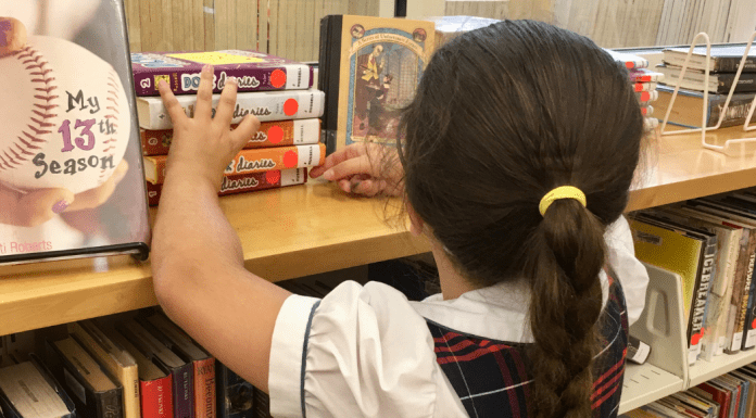 Image: A child looks for books at a local library