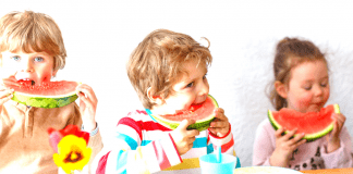 Healthy Living 2022 for YOU and Your Family! Three children enjoying slices of watermelon as a healthy snack