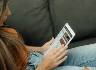 Top 10 Blog Posts of 2021 Image: Woman sitting and reading on her tablet (Top 10 Blog Posts of 2021 Lynda Lantz Editor Miami Mom Collective)