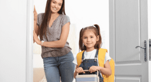Image: A mom looks on as her daughter walks out the door, ready for school (School Mornings: 11 Hacks to Make Them Easy (Ok, "Easier") Candice Carricarte Contributor Miami Mom Collective)