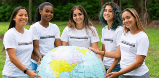 Image: A group of young women holding a large inflatable globe
