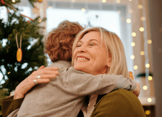 Holiday Travel and Gatherings: Protecting Your Family From COVID & Flu Image: A grandmother hugging her grandson at Christmas (Holiday Travel and Gatherings: Protecting Your Family From COVID & Flu Lynda Lantz Editor Miami Mom Collective)