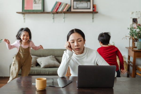 Image: A mom works from home while her son and daughter play (Minnie Roca Contributor Miami Mom Collective)