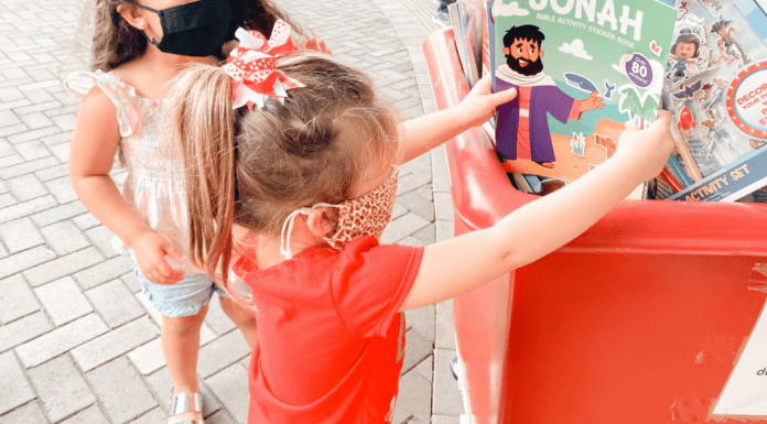 Christmas: An Awesome Opportunity to Volunteer as a Family Image: A child donating a toy (Christmas: An Awesome Opportunity to Volunteer as a Family Holly Farver Contributor Miami Mom Collective)
