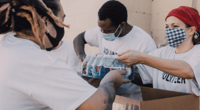 Image: Service volunteers packing aid boxes (Giving Tuesday 2021: A Global Effort to Bring the World Together Sharonda Stewart Contributor Miami Mom Collective)