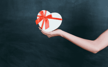 Image: An outstretched arm holding a gift box