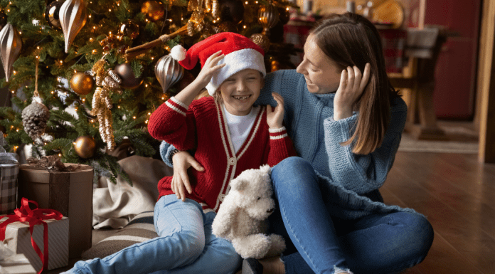 Healthy Holidays: A Survival Guide | Part 1 Image: A mother and daughter sitting in front of their Christmas tree