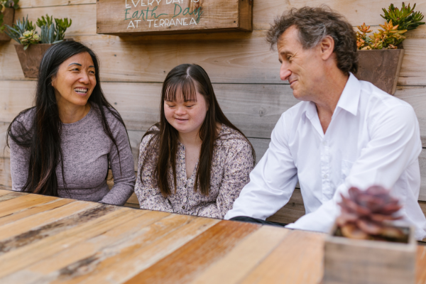 Image: A family sitting at a table together