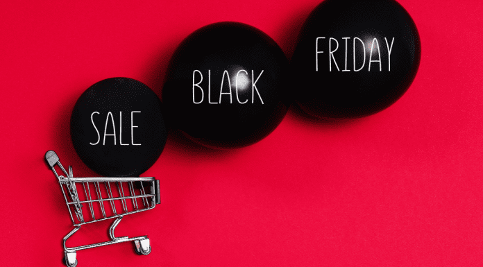 Image: A shopping cart and black balloons that read "Sale Black Friday" (Black Friday Deals: 5 Ways to Make the Most of Them Ana-Sofia DuLaney Contributor Miami Mom Collective)