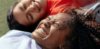 Dental Hygiene Month: Brush Up on Oral Care | Dr. Bob Pediatric Dentist Image: Two multiethnic girls laughing and smiling together (Dental Hygiene Month: Brush Up on Oral Care | Dr. Bob Pediatric Dentist Lynda Lantz Contributor Miami Mom Collective)