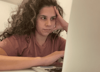 5 Tips to Manage Stress Through Motherhood Image: Zoe sitting in front of her computer (5 Tips to Manage Stress through Motherhood Zoe Costa Contributor Miami Mom Collective)