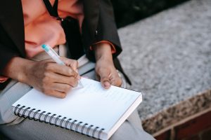 Image: A woman writing in a journal (Zoe Costa Contributor Miami Mom Collective)