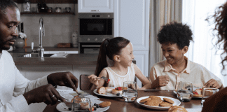 Image: A family sitting around the dinner table (How to Deal With a Picky Eater Dina Garcia Contributor Miami Mom Collective)