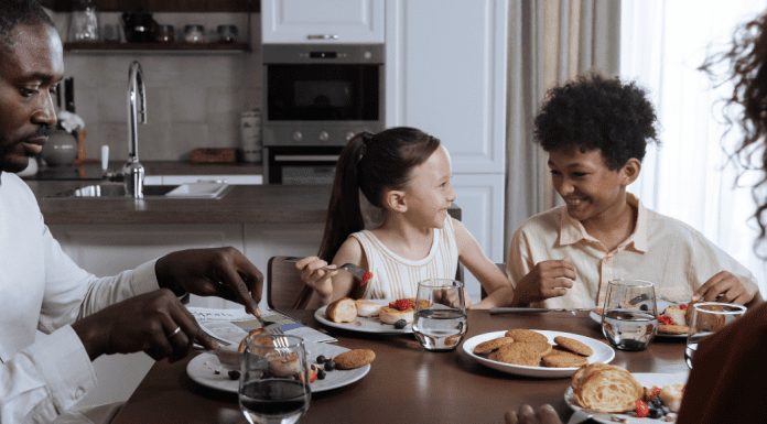 Image: A family sitting around the dinner table (How to Deal With a Picky Eater Dina Garcia Contributor Miami Mom Collective)