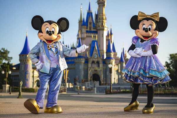 Image: Micky and Minnie Mouse in front of Cinderella's Castle (Sandra Jacquemin Contributor Miami Mom Collective)