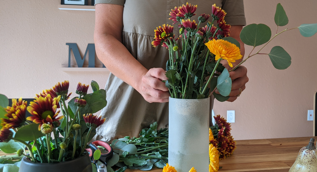 Image: Rachel arranging some mums in a vase (Get the Fall Feeling in Miami Rachel Hulsund Contributor Miami Mom Collective)