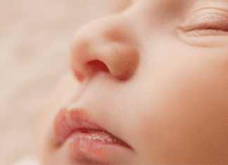A picture of a sleeping baby's face (Baby Safety Month: Helpful Tips for Keeping Your Little One Safe Dianna Hill Contributor Miami Mom Collective)