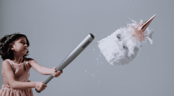 Hispanic Heritage Month: 15 Ways to Celebrate A girl hitting a pinata (Hispanic Heritage Month: Ways to Celebrate Lorena Lougedo Contributor Miami Mom Collective)