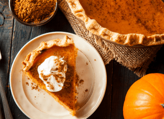Image: A slice of pumpkin pie on a festive table