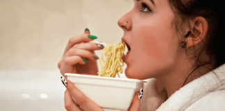 What To Do If You Can’t Stop Eating A woman eating a bowl of ramen noodles