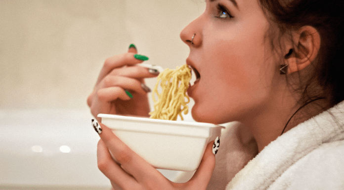 What To Do If You Can’t Stop Eating A woman eating a bowl of ramen noodles