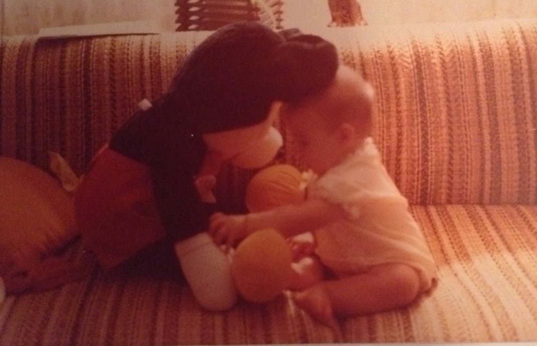 A picture of Sandra as an infant with her first Mickey toy (Disney Has Some Secrets, Sort Of Sandra Jacquemin Contributor Miami Mom Collective)