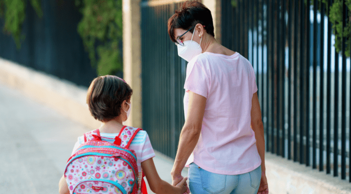 A mother and daughter walking to school (Kids and Tech: Back to School in a Pandemic Be Strong International Miami Mom Collective)