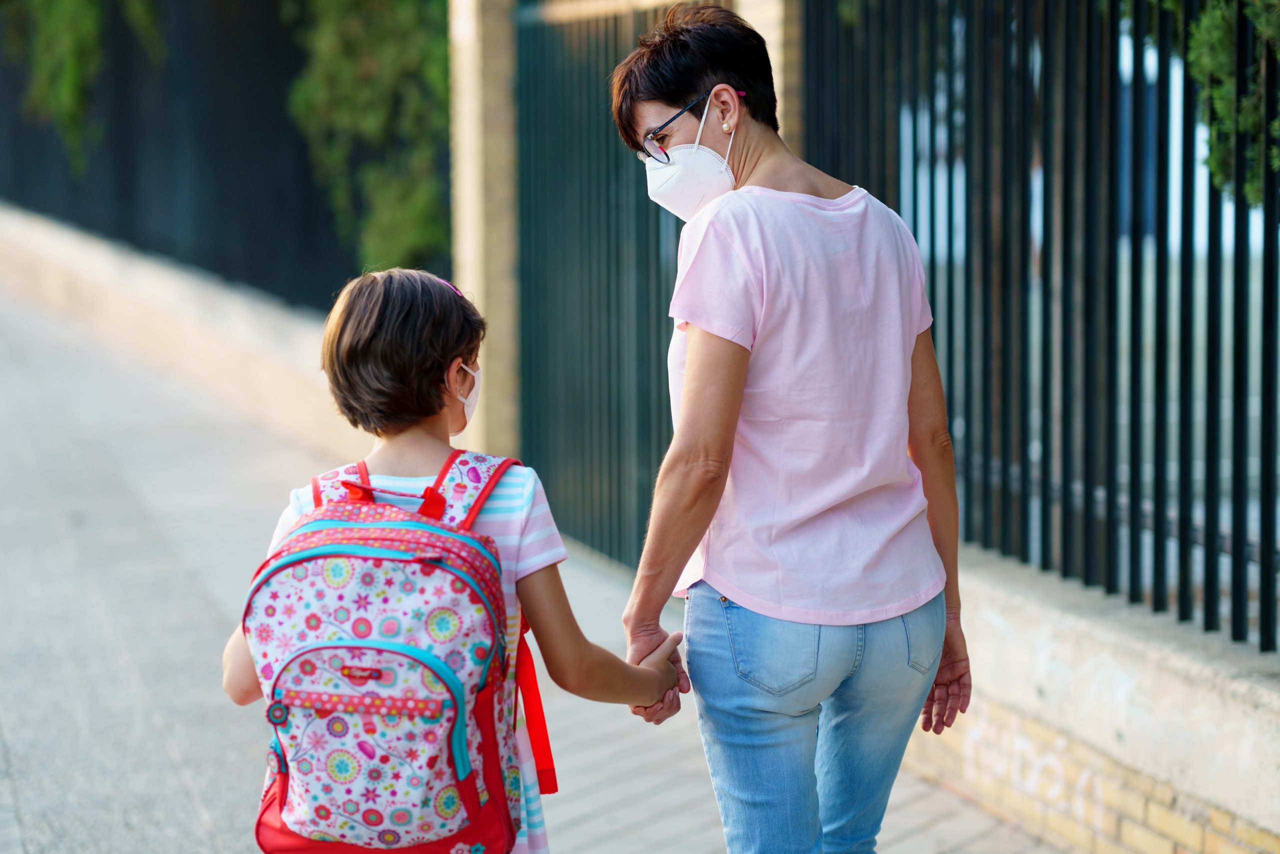 A mother and daughter walking to school (Kids and Tech: Back to School in a Pandemic Be Strong International Miami Mom Collective)