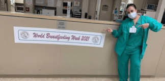 A nurse posing next to a banner for World Breastfeeding Week (World Breastfeeding Week: Raising Global Awareness Alexa Gonzalez Contributor Miami Mom Collective)
