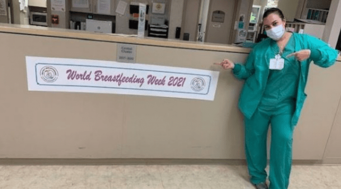 A nurse posing next to a banner for World Breastfeeding Week (World Breastfeeding Week: Raising Global Awareness Alexa Gonzalez Contributor Miami Mom Collective)