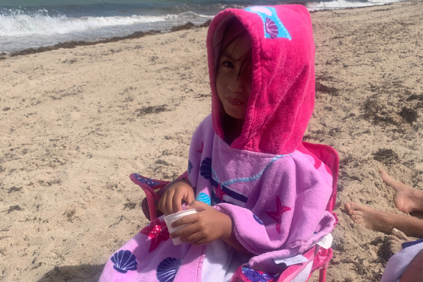 Jessica's daughter wearing a hooded towel (Jessica Alvarez-Ducos Contributor Miami Mom Collective)