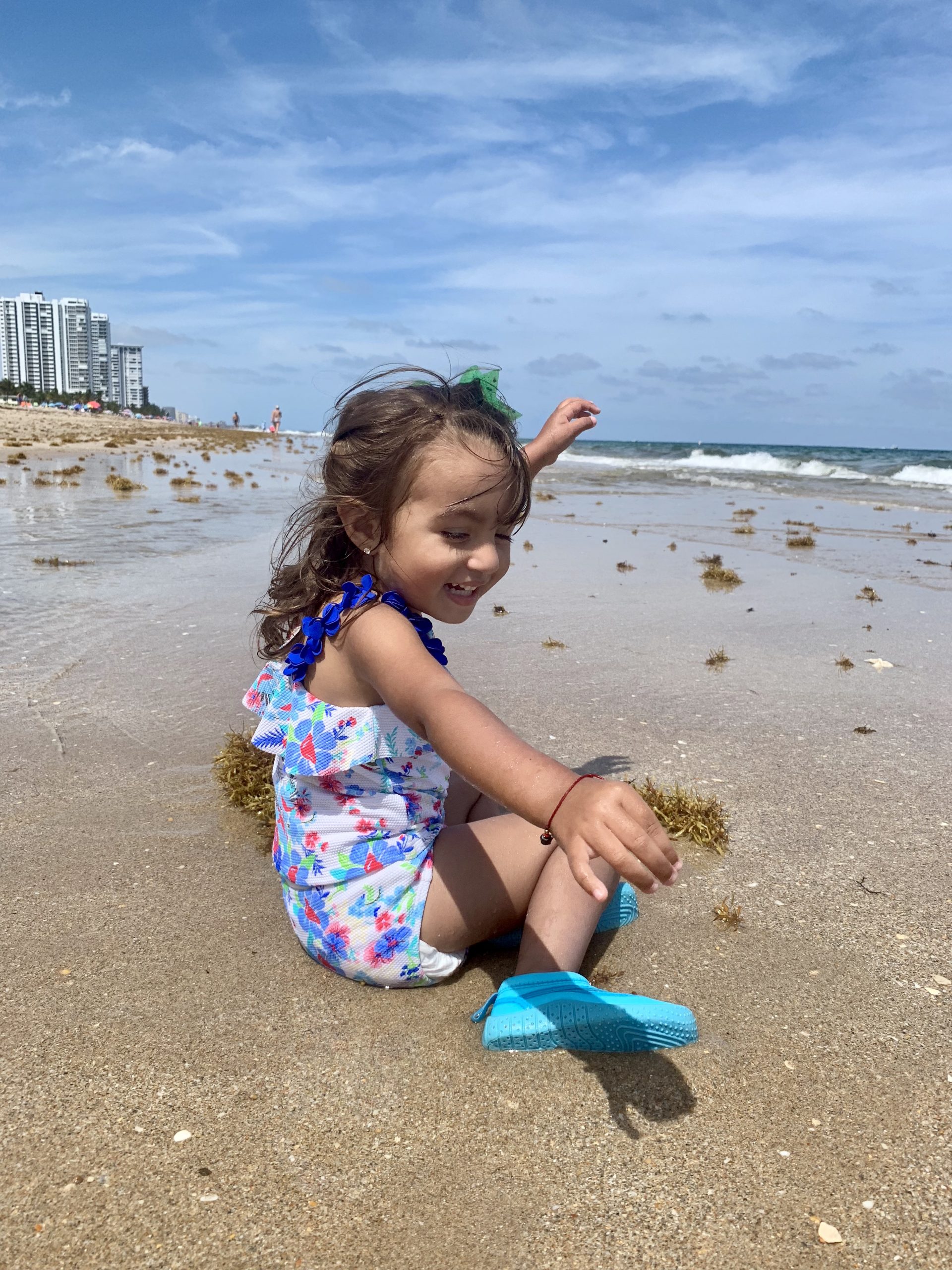 Julie's daughter exploring the beach (Beach More, Stress Less : Beach Day Tips and Hacks Jessica Alvarez-Ducos Contributor Miami Mom Collective)