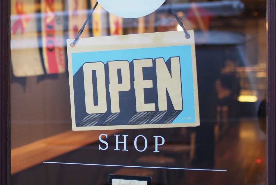 An "OPEN" sign on the front door of a local business (August is Black Business Month: 3 Ways to Support Black Businesses Sharonda Stewart Contributor Miami Mom Collective)