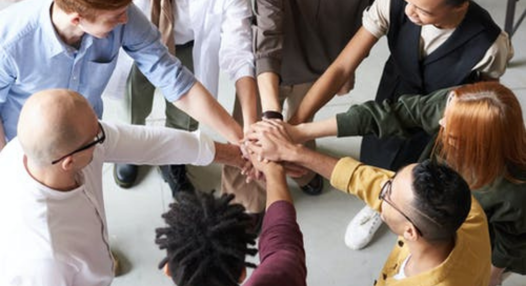 A group of people in a huddle (Your Child Votes YES! Getting Involved at Your Child's School Matters! Holly Farver Contributor Miami Mom Collective)