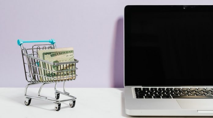 A laptop and a small grocery cart full of cash (Bargain Hunting: Money Saving Tips for Online Shopping Ana-Sofia DuLaney Contributor Miami Mom Collective)