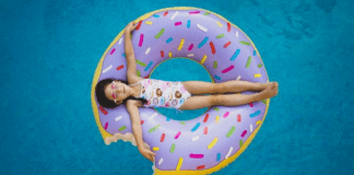 A little girl on a donut shaped inner tube