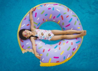 A little girl on a donut shaped inner tube