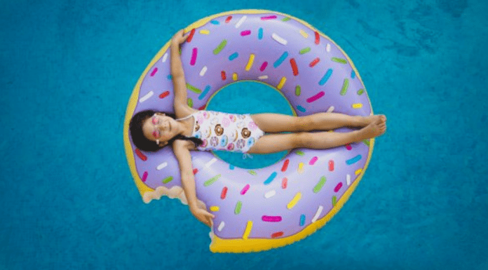 A little girl on a donut shaped inner tube