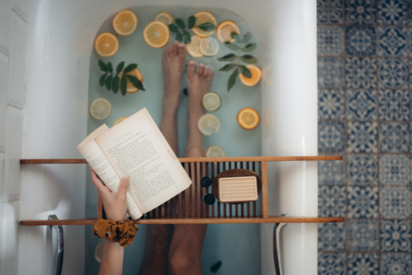 Reading a book in the bath (Summer Reading List for Moms Krystal Giraldo Contributor Miami Mom Collective)