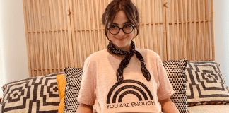 Postpartum Mental Health Disorders: Let’s Break the Stigma Jacqueline posing with a rainbow t-shirt that reads, "You are enough."