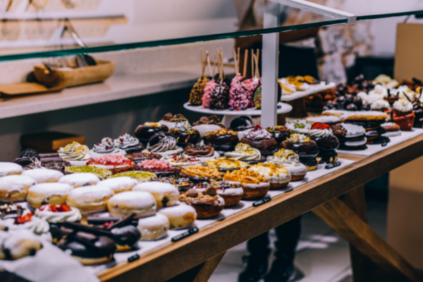A bakery counter full of donuts and sweet treats (National Donut Day: Make it A-Glaze-ing! Ana-Sofia DuLaney Contributor Miami Mom Collective)